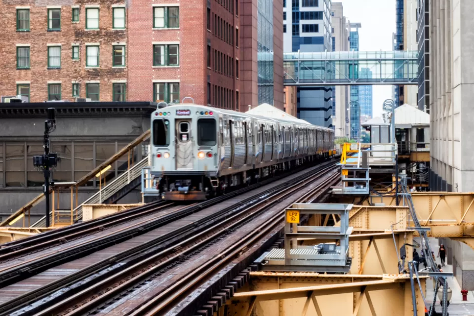 CHicago elevated train passing by brick buildings